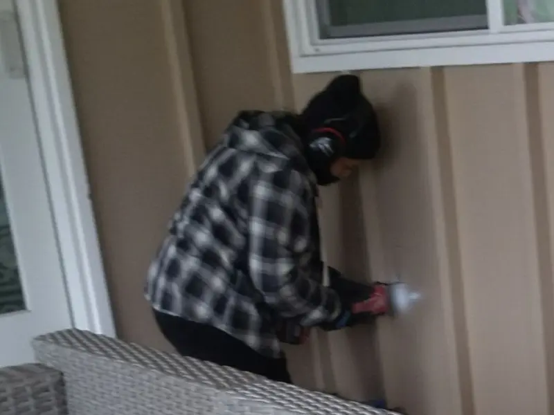 Professional electrician installing an exterior outlet in Holden